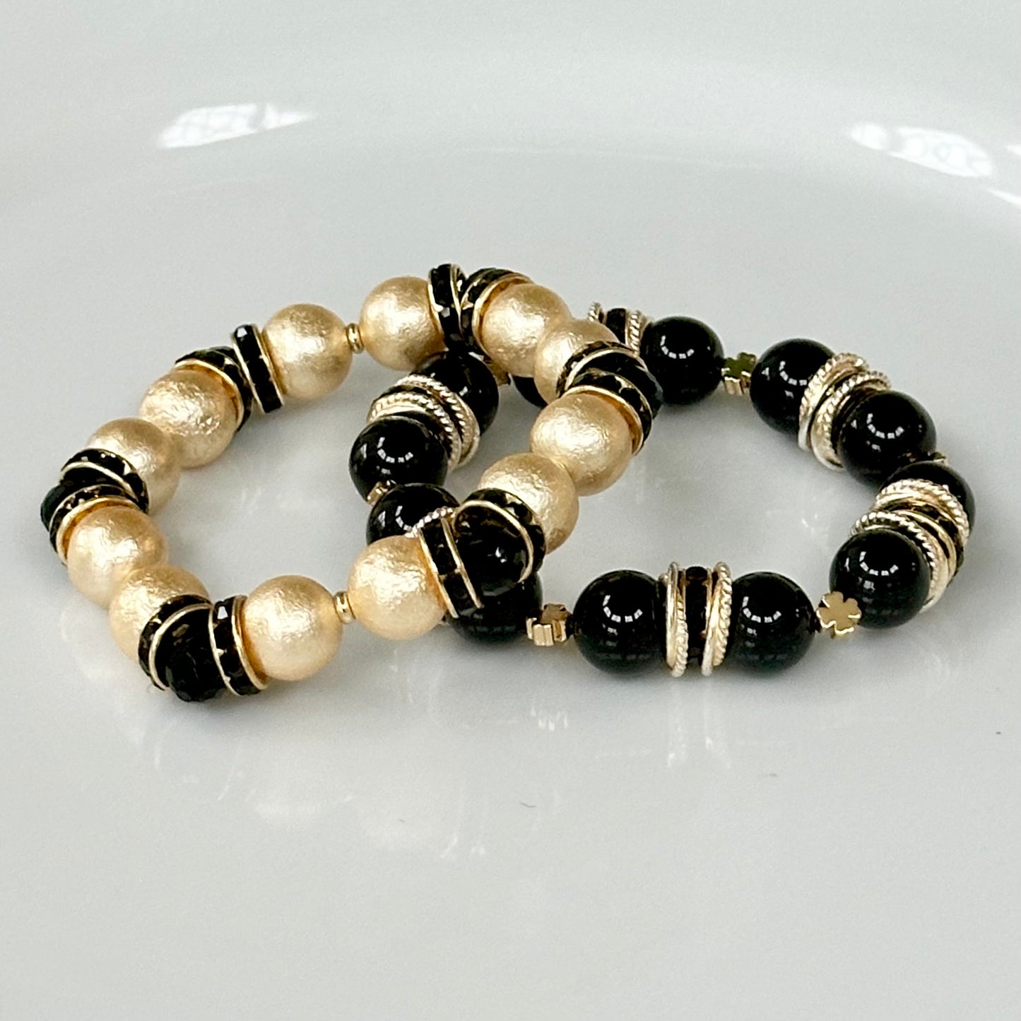 GOLD SHELL PEARL BANGLE WITH BLACK CRYSTAL ACCENTS