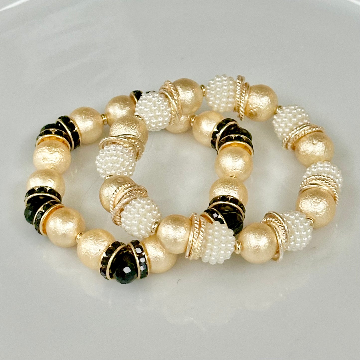GOLD SHELL PEARL BANGLE WITH BLACK CRYSTAL ACCENTS