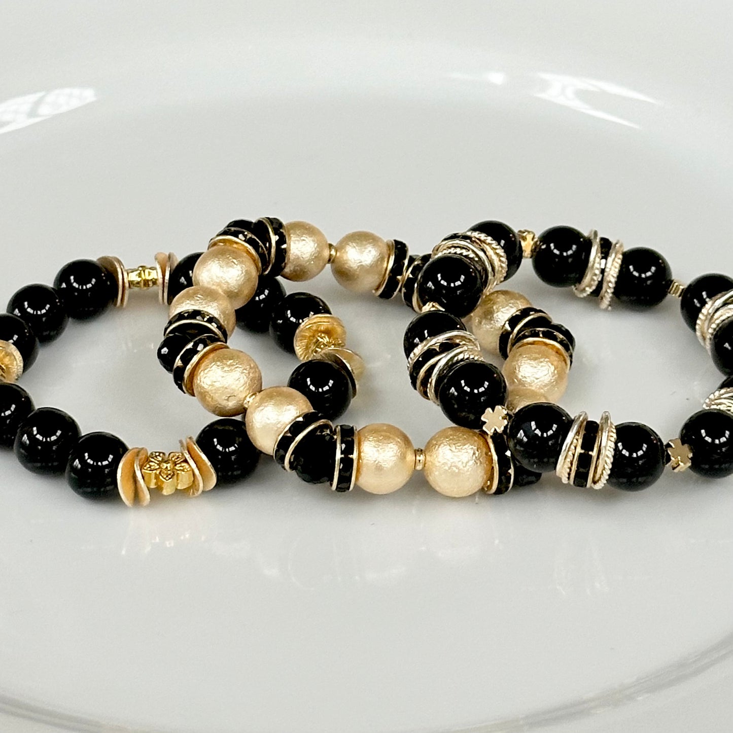 GOLD SHELL PEARL BANGLE WITH BLACK CRYSTAL ACCENTS