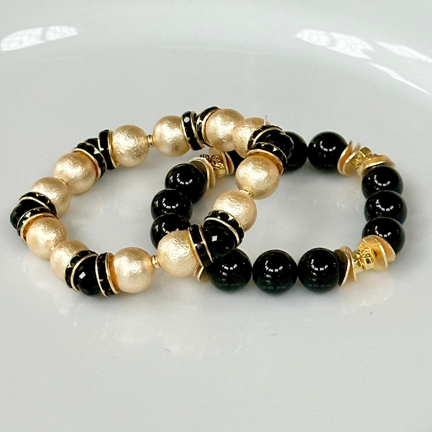 GOLD SHELL PEARL BANGLE WITH BLACK CRYSTAL ACCENTS