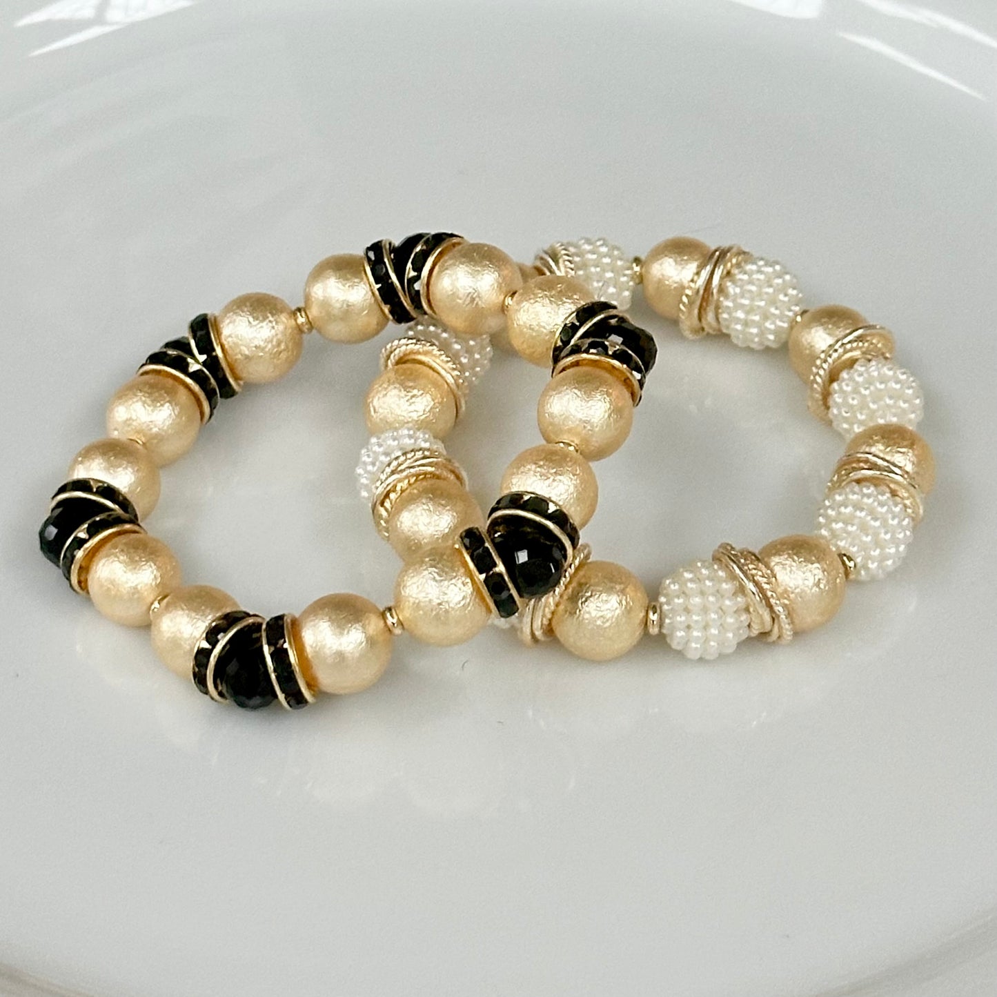 GOLD SHELL PEARL BANGLE WITH BLACK CRYSTAL ACCENTS