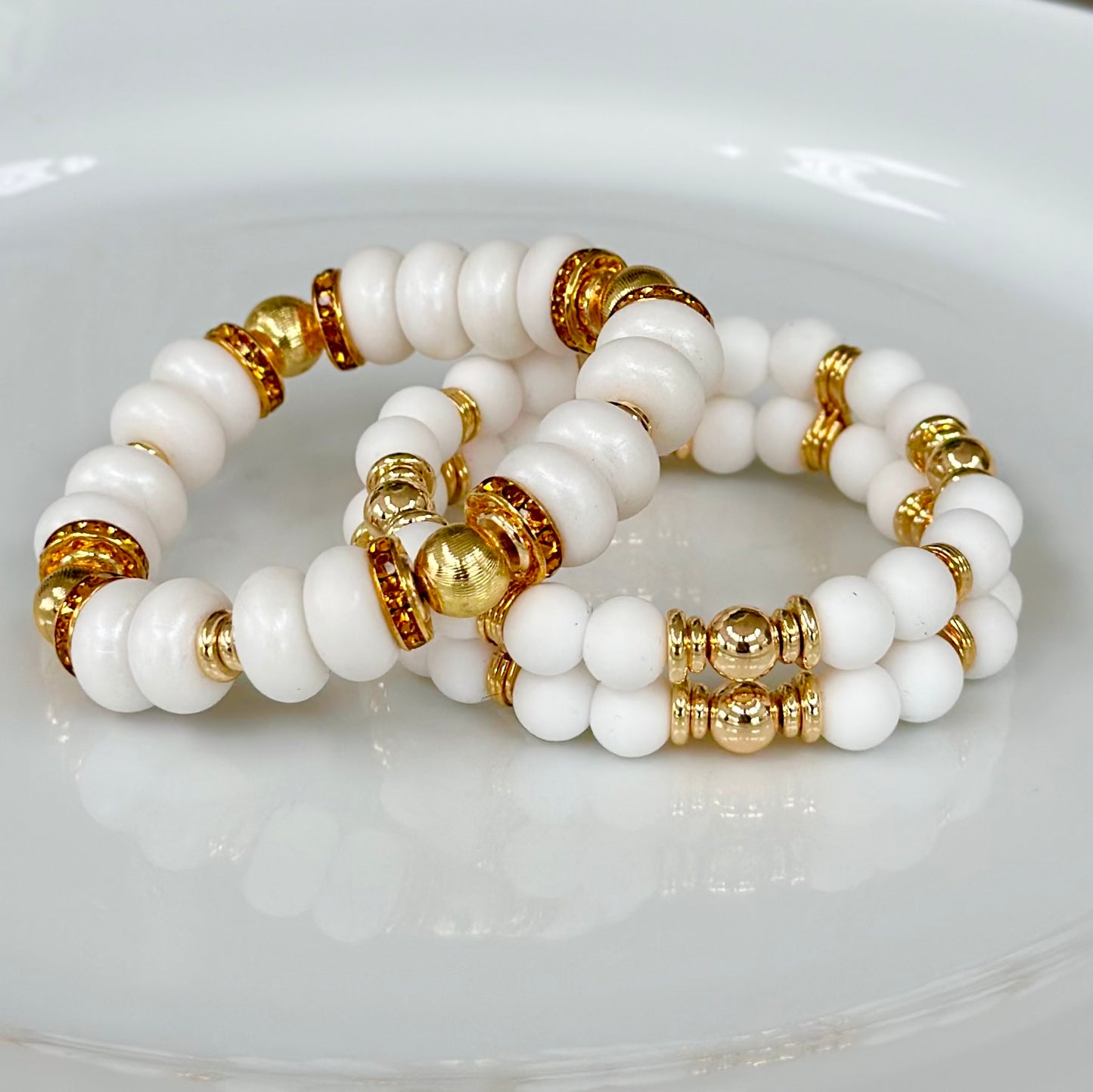 WHITE SPIRAL BANGLE WITH AMBER CZ ACCENTS