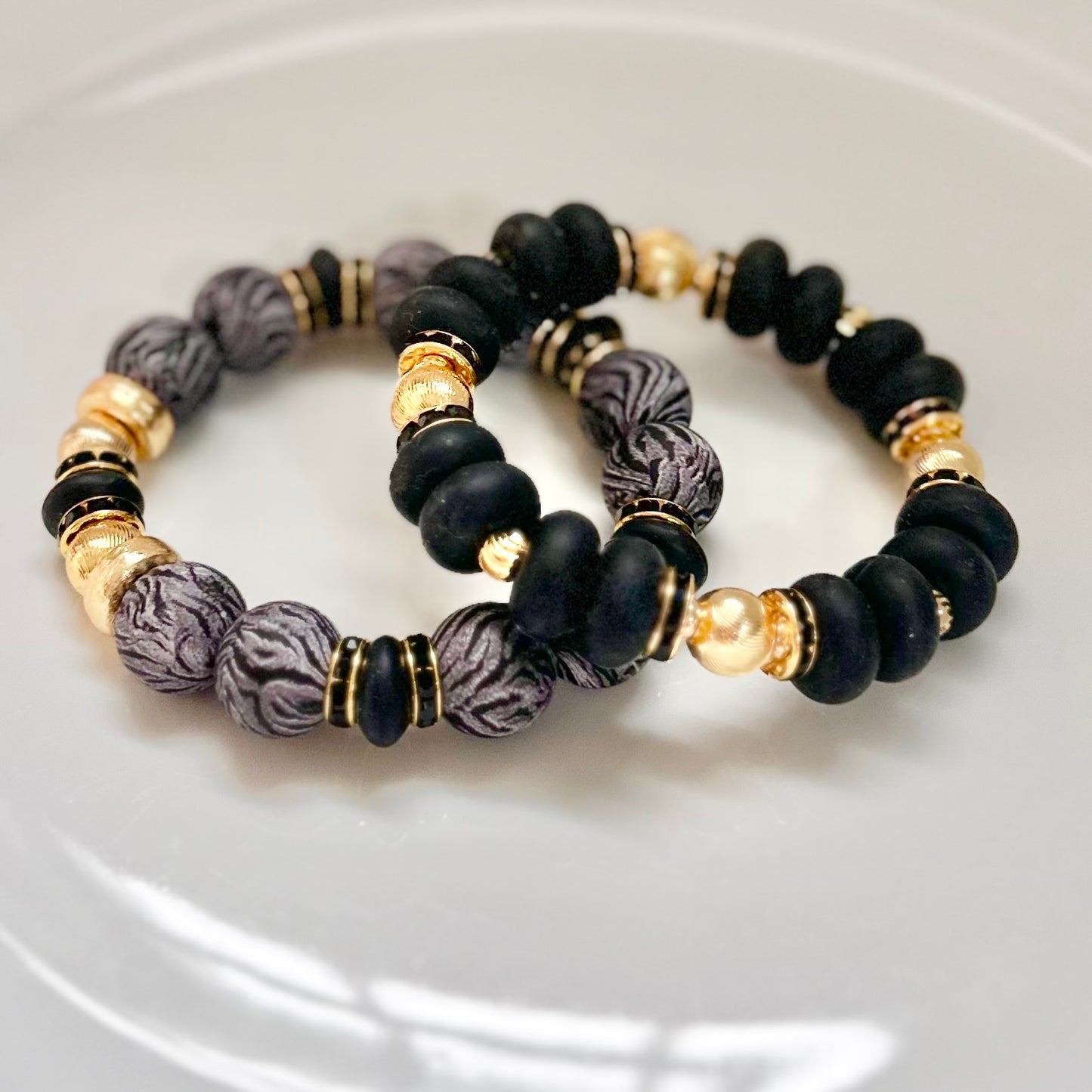 BLACK SPIRAL BANGLE WITH GOLD AND BLACK CZ ACCENTS