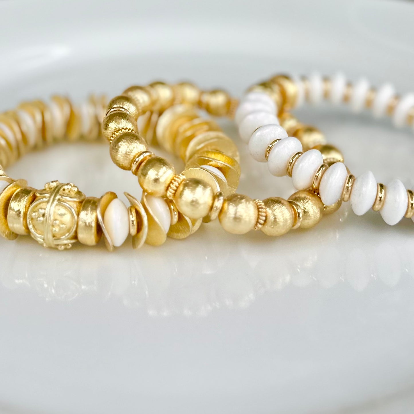 GOLD WAVY DISC AND WHITE STATEMENT BRACELET