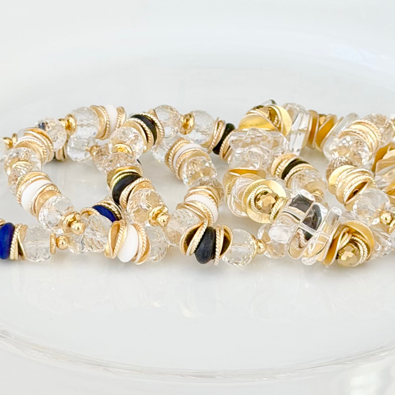FACETED LUCITE BANGLE WITH GOLD, WAVY DISC AND NAVY BLUE ACCENTS