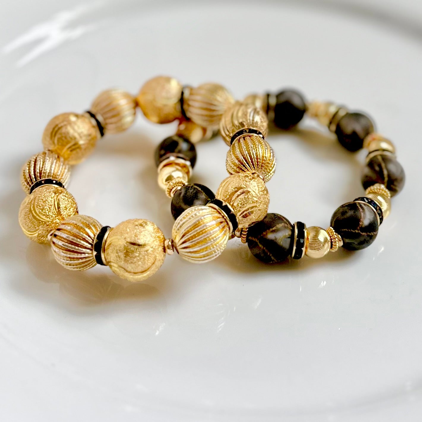 RIBBED AND TEXTURED GOLD STATEMENT BRACELET WITH BLACK ACCENTS