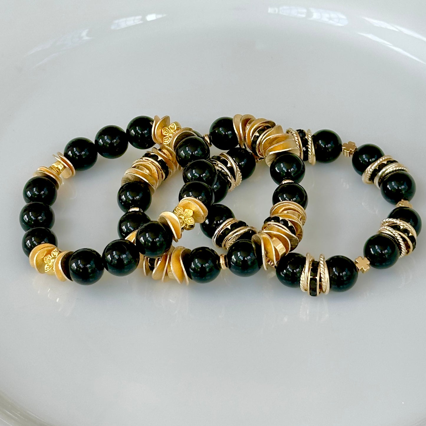 BLACK ONYX GEMSTONE BANGLE WITH GOLD WAVY DISC AND FLOWER ACCENTS