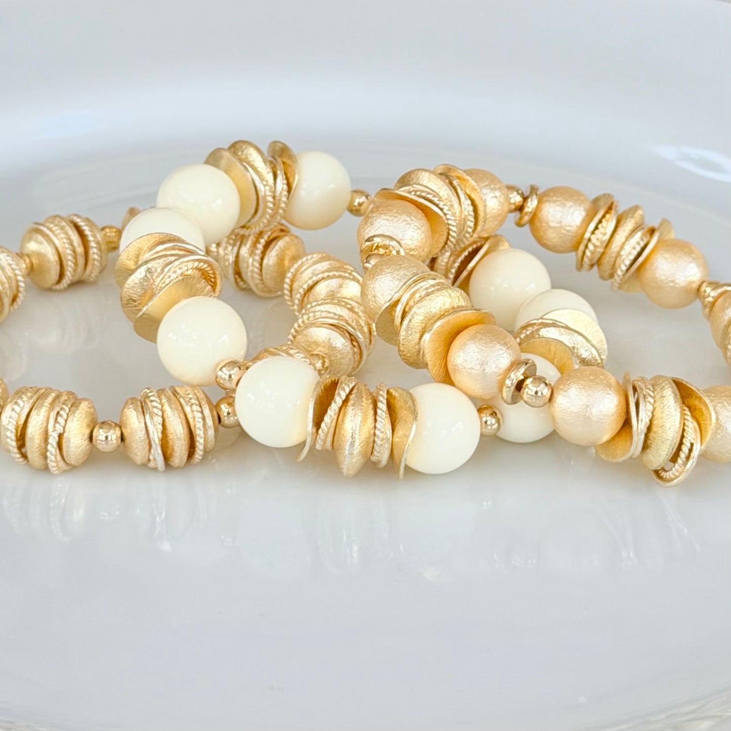 GOLD AND SHELL PEARL BANGLE WITH GOLD WAVY DISC AND GOLD ACCENTS