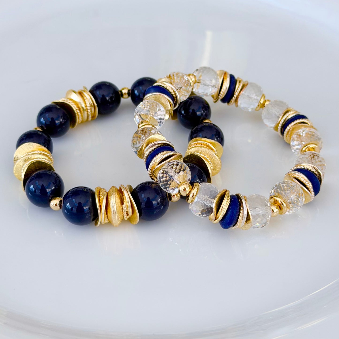 FACETED LUCITE BANGLE WITH GOLD, WAVY DISC AND NAVY BLUE ACCENTS