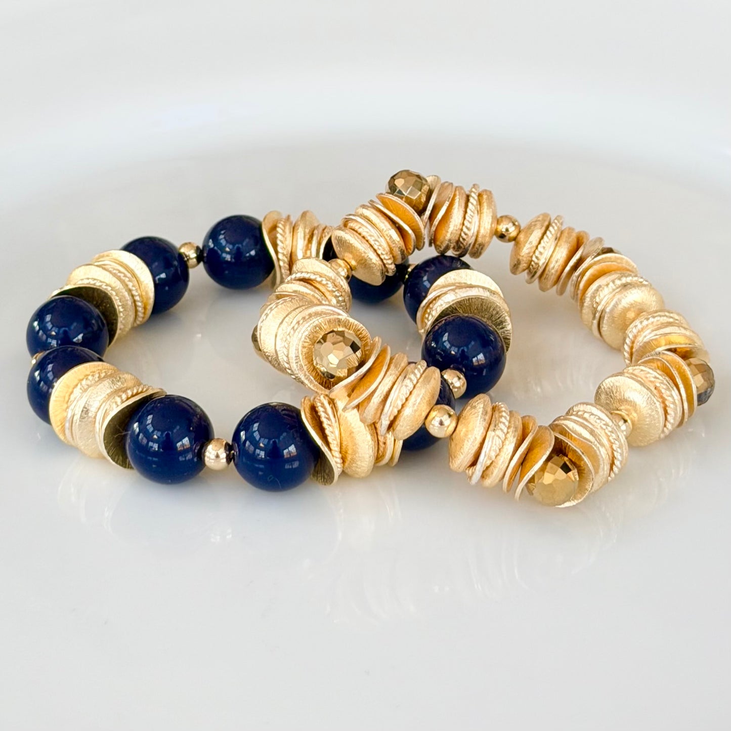 NAVY BLUE BANGLE WITH BRUSHED GOLD WAVY DISC AND GOLD ACCENTS