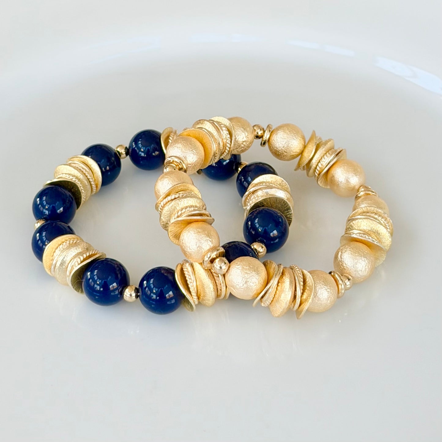 GOLD AND SHELL PEARL BANGLE WITH GOLD WAVY DISC AND GOLD ACCENTS