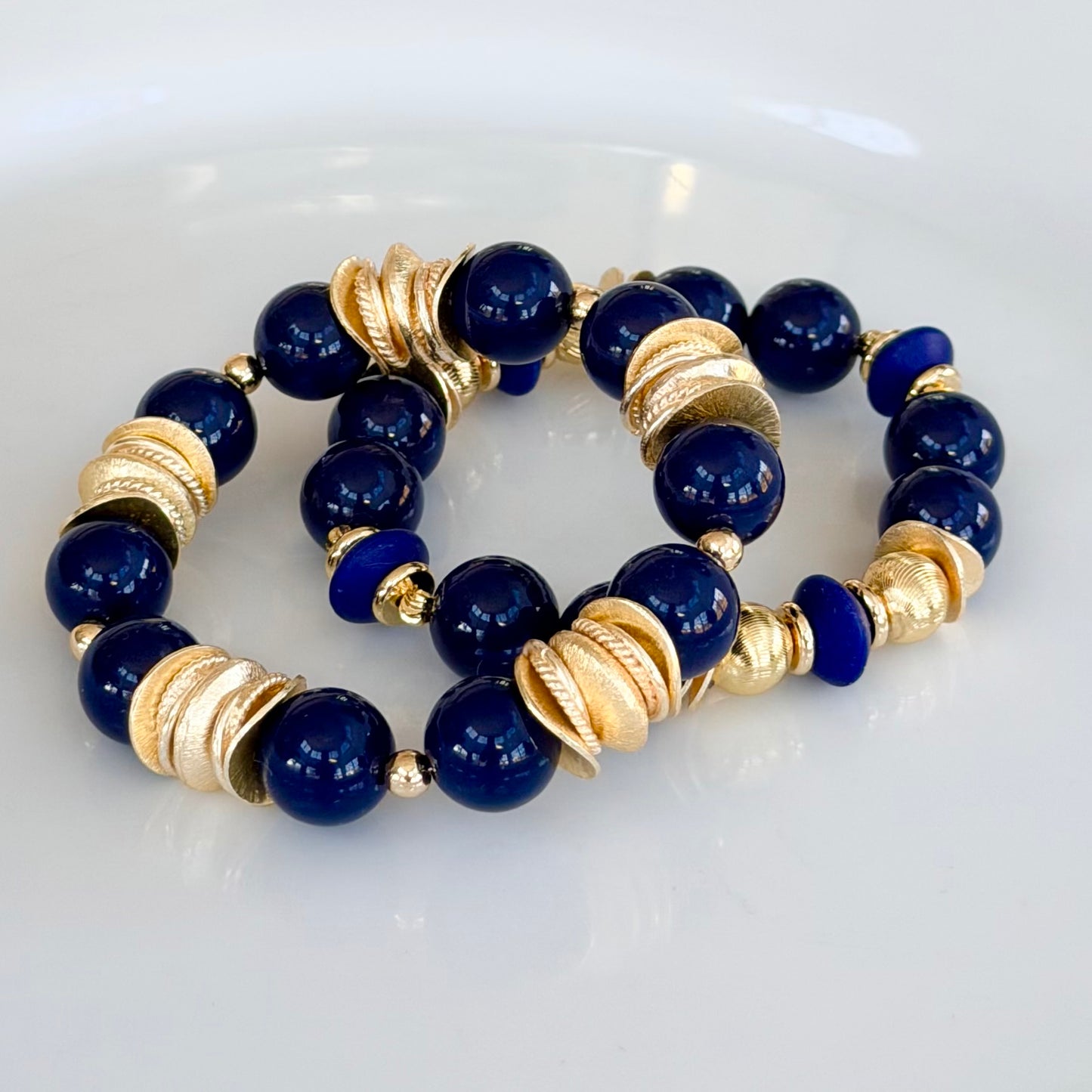 NAVY BLUE BANGLE WITH BRUSHED GOLD WAVY DISC AND GOLD ACCENTS