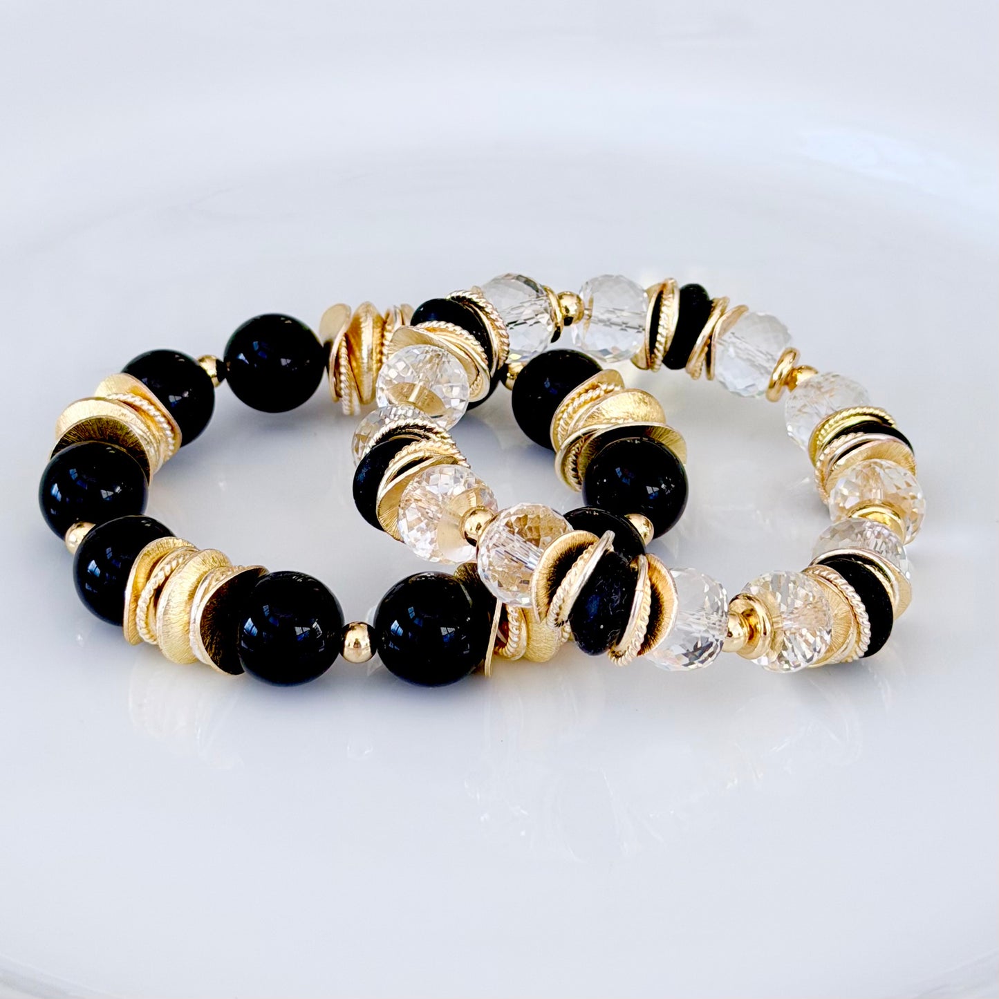 FACETED LUCITE BANGLE WITH GOLD, WAVY DISC AND BLACK ACCENTS