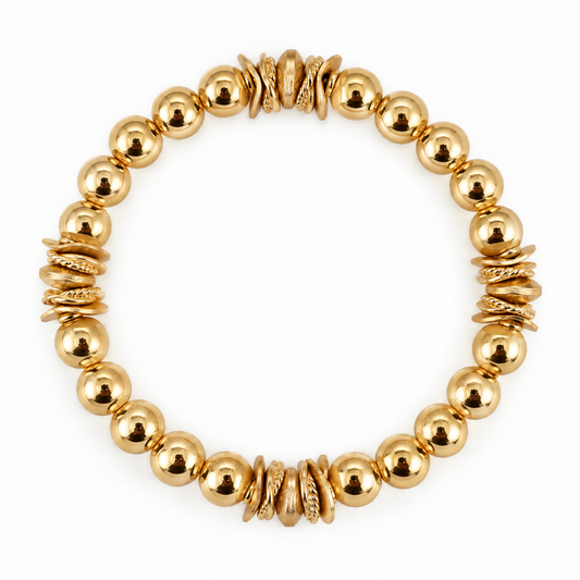 THE WYNN BANGLE IN GOLD WITH WAVY DISC ACCENTS