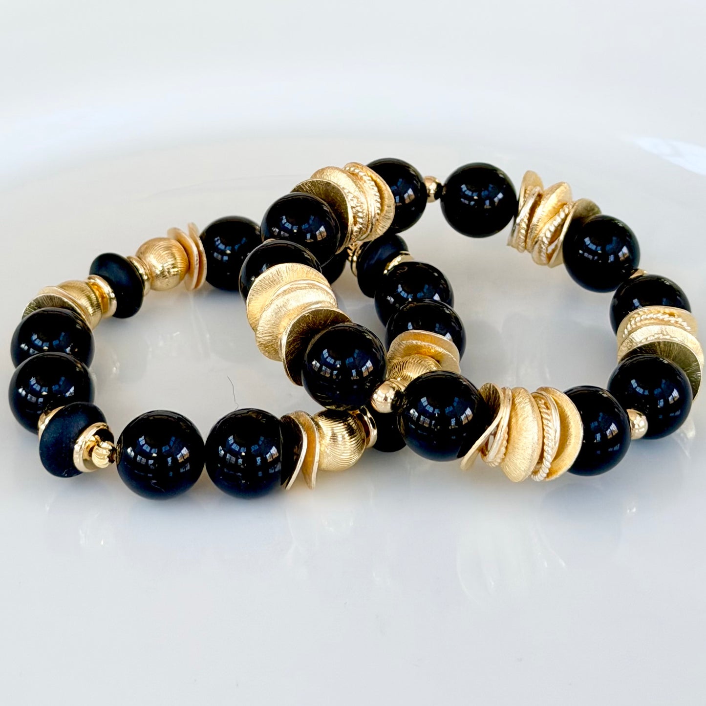 BLACK AND GOLD WAVY DISC BANGLE WOTH GOLD AND BLACK ACCENTS