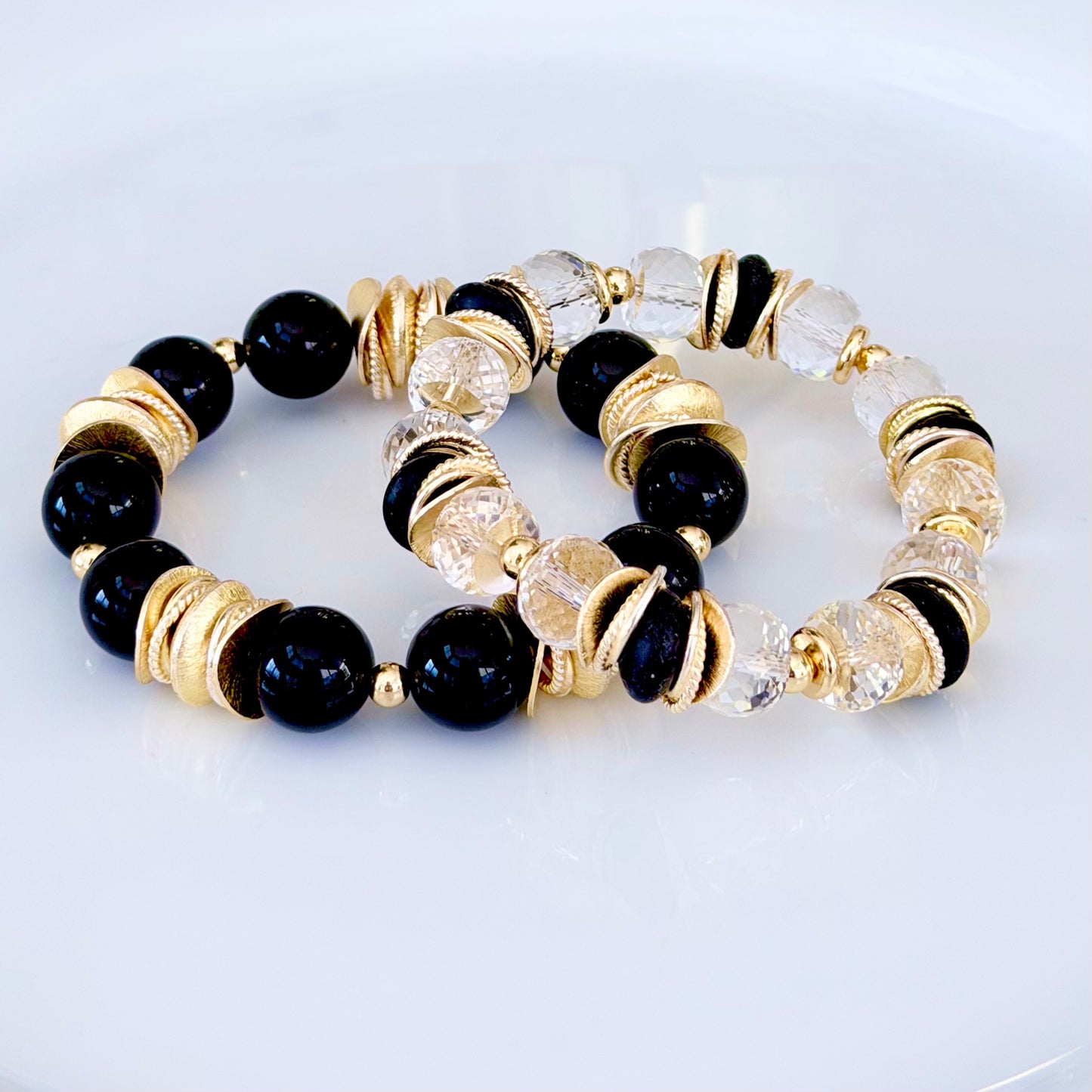 FACETED LUCITE BANGLE WITH GOLD, WAVY DISC AND BLACK ACCENTS