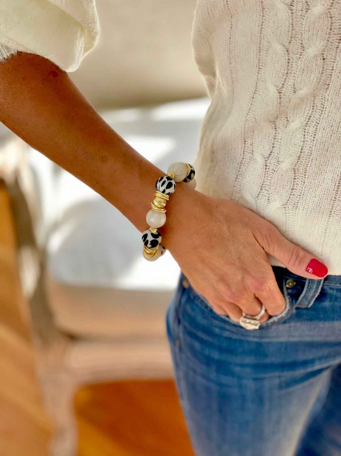 BLACK AND IVORY COW PATTERN BANGLE WITH GOLD ACCENTS