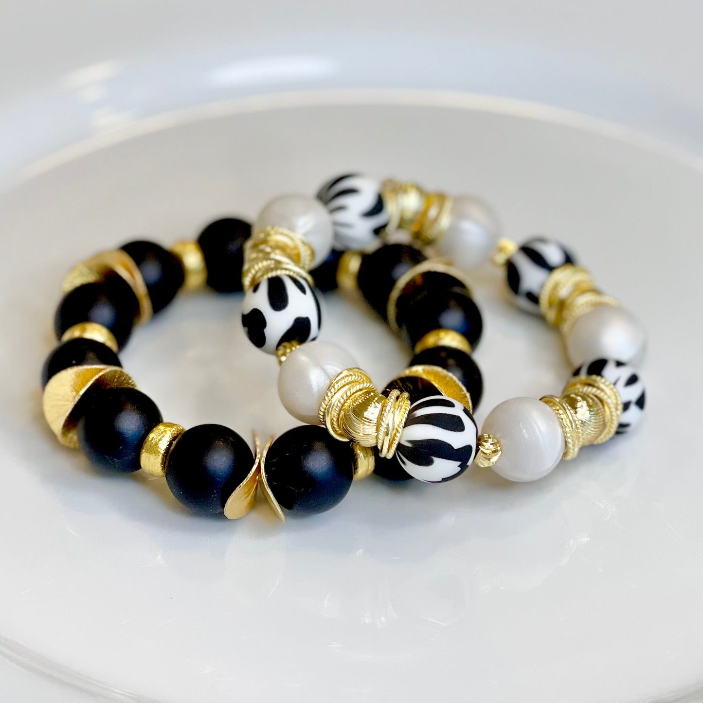 BLACK AND IVORY COW PATTERN BANGLE WITH GOLD ACCENTS